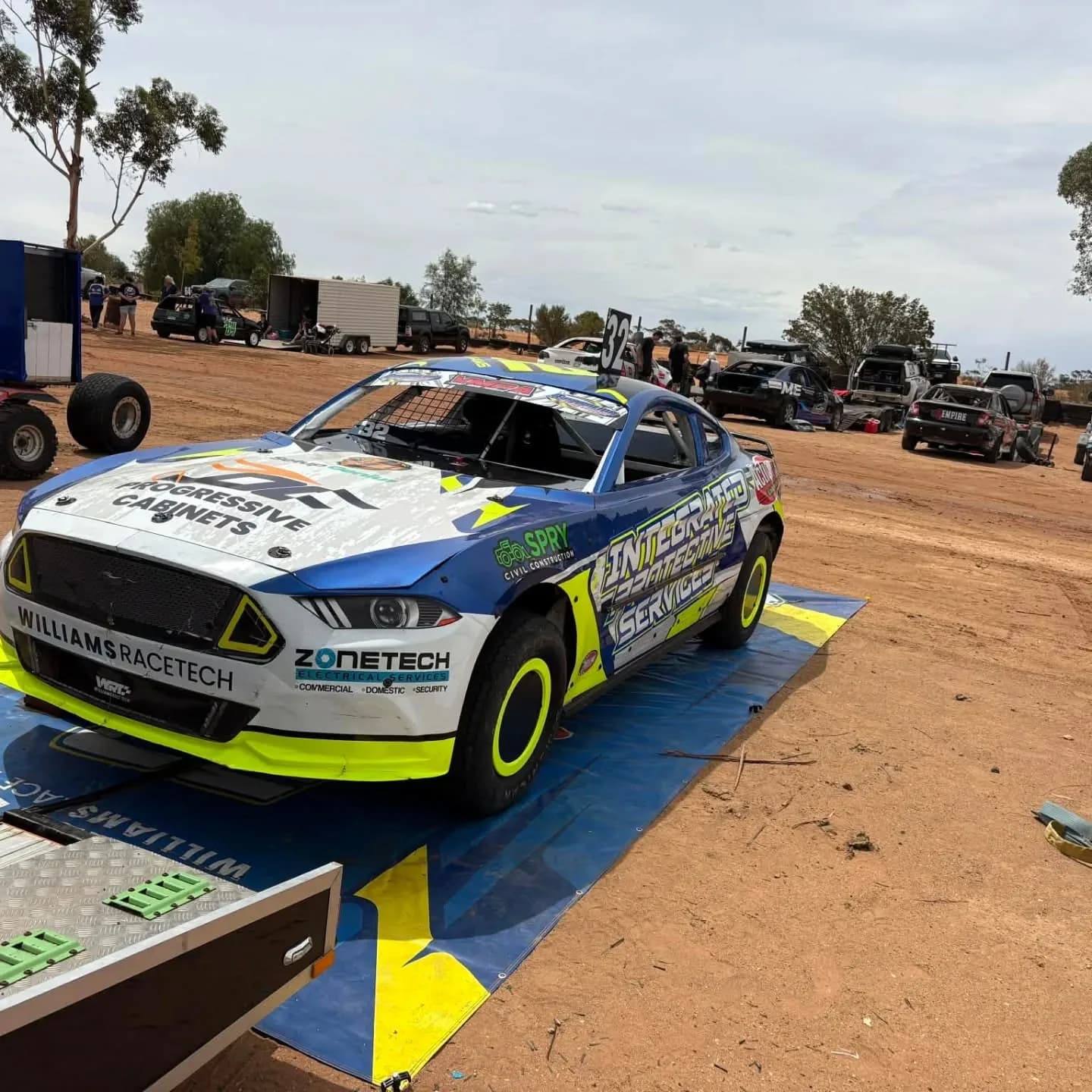 WRT #32 Ford Mustang front three-quarter in the paddock